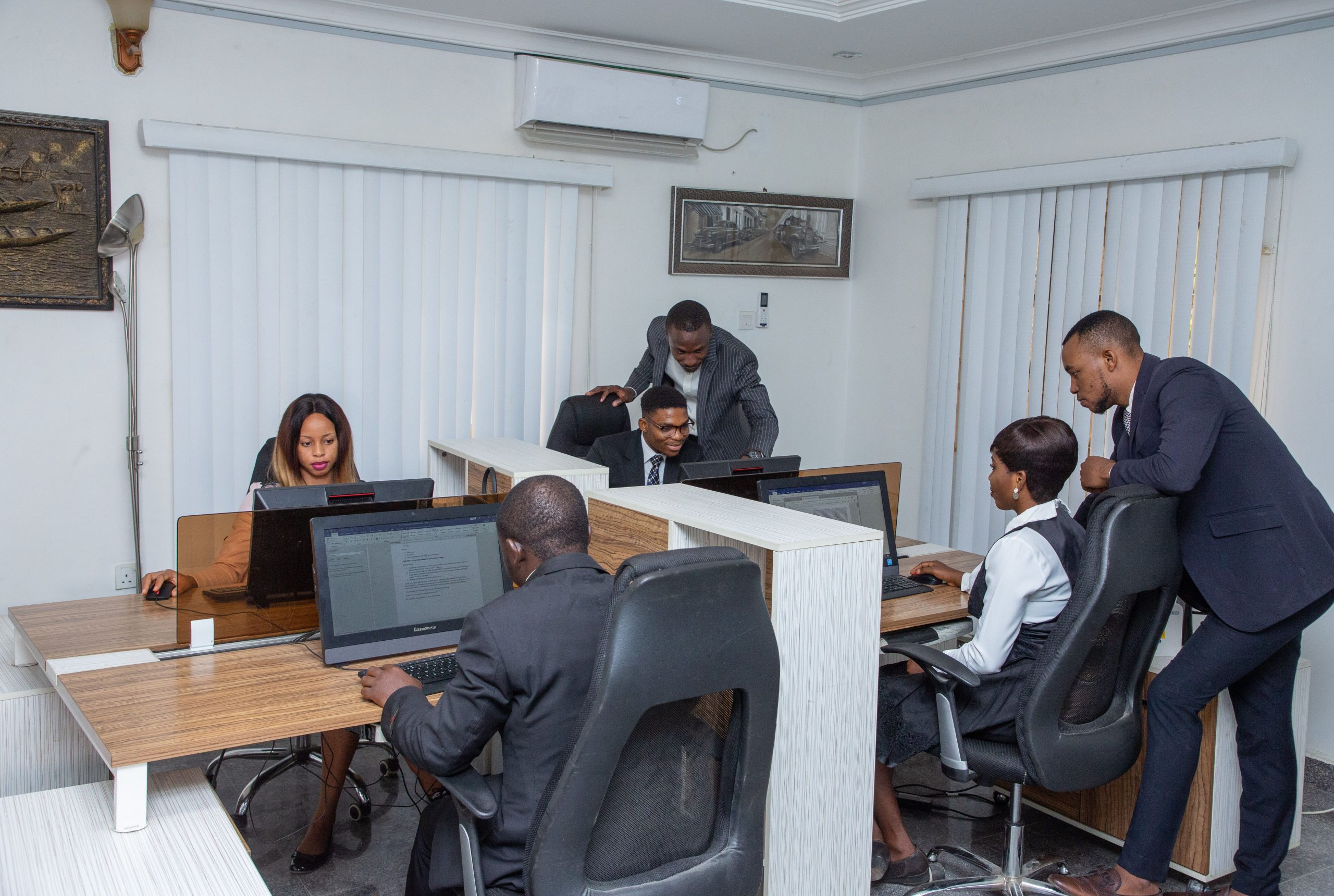 About A group of professionals working together in a modern office setting, emphasizing teamwork and productivity.